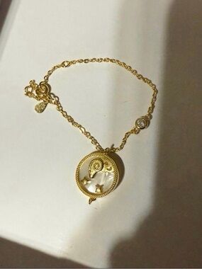 Aries Ram mother of pearl bracelet with topaz accent stone.